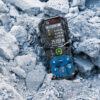 Ruggedized rubber housing on a Bosch 50m laser measure sitting in construction site debris.